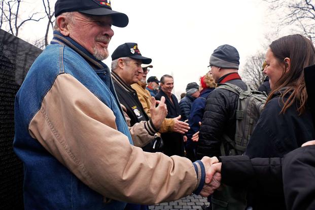 Former soldier Gale 'Caje' Shire leads a receiving line of the 'Currahee Brothers' at the Vietnam Veterans Memorial in Washington, D.C.