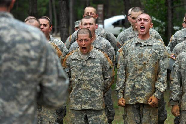 Army recruits run Fort Benning obstacle course.