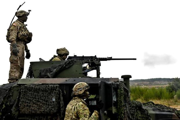 Army Sgt. Jaquez Jones, left, observes a soldier firing a mounted M2 .50 cal. Browning machine gun during live-fire training at Wedrzyn, Poland, Nov. 30, 2016. (Photo: U.S. Army)