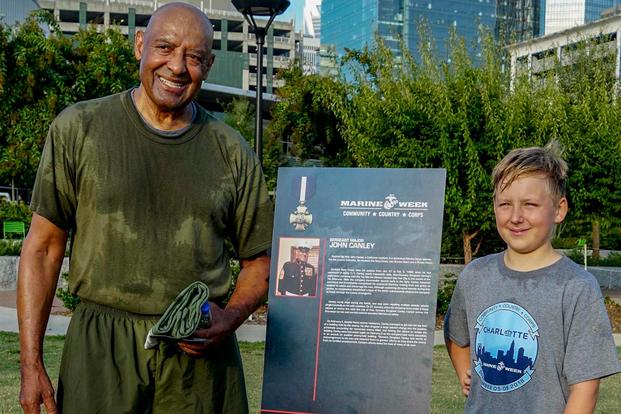 Retired U.S. Marine Corps, retired, Sgt. Maj. John Canley, left, and a local citizen pose for a photo after a physical training session during Marine Week in Charlotte, N.C., Sept. 7 2018. (U.S. Marine Corps/ Cpl. Careaf Henson)