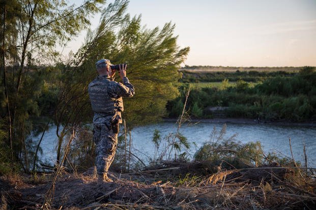 A soldier from the 36th Infantry Division, Texas Army National Guard observes a section of the Rio Grande River at sunset, Sept. 11, 2014. (U.S. Army photo/Randall Stillinger)