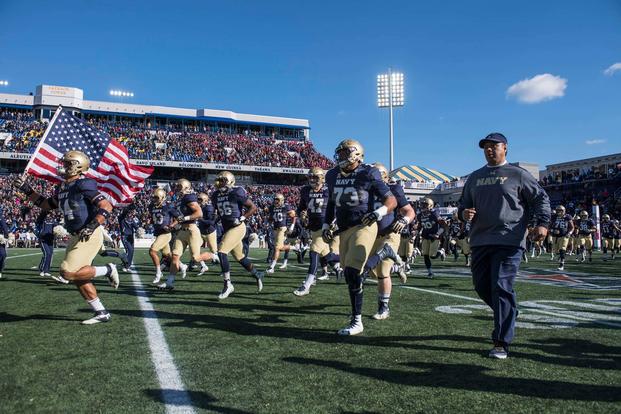U.S. Naval Academy Midshipmen Head Football Coach Ken Niumatalolo enters the stadium with his team prior to the start of a game against the Temple Owls, Dec. 3, 2016.  (U.S. Navy photo by Chief Petty Officer Anthony Koch)
