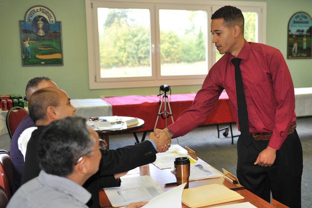 Spc. Joshua Walton, a soldier assigned to the Warrior Transition Battalion-Europe, greets interview panel members during his mock interview Sept. 18 at Baumholder's Rolling Hills Golf Club.