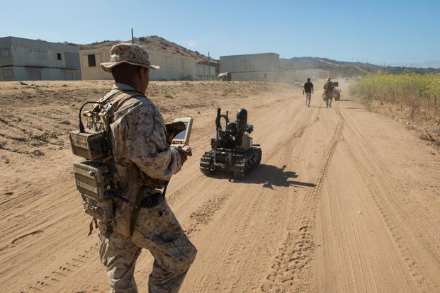 Pfc. Edgar Langle operates a newly developed Modular Advanced Armed Robotic System in a field environment at Marine Corps Base Camp Pendleton, Calif., July 8, 2016. (U.S. Marine Corps/ Lance Cpl. Julien Rodarte)