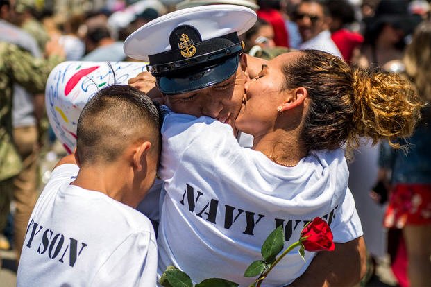 Navy Chief Petty Officer Miguel Mosquera hugs his family in San Diego, May 7, 2018, upon returning from a deployment aboard the aircraft carrier USS Theodore Roosevelt. (U.S. Navy photo by Seaman Nick Bauer)