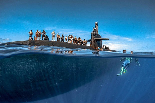 Sailors assigned to Los Angeles-class fast-attack submarine USS Olympia participate in a swim call at sea in the Pacific Ocean, July 31, 2018. (U.S. Navy photo by Senior Chief Petty Officer Vien Nguyen)