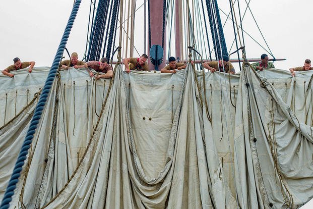 Sailors learn how to furl a topsail from 175 feet above the deck of USS Constitution in Boston, Aug. 14, 2018. (U.S. Navy photo by Petty Officer 1st Class Joshua Hammond)