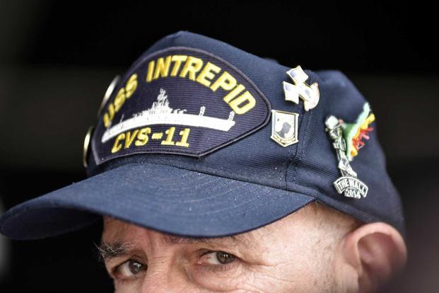 A plank owner of the USS Intrepid (CVS 11) observes the Intrepid Sea, Air & Space Museum Memorial Day ceremony on May 30, 2016. The ship was in Vietnam's territorial waters during the Vietnam War. Some veterans say they were exposed to Agent Orange during that time. (U.S. Navy photo by Mass Communication Specialist 1st Class Julie Matyascik)