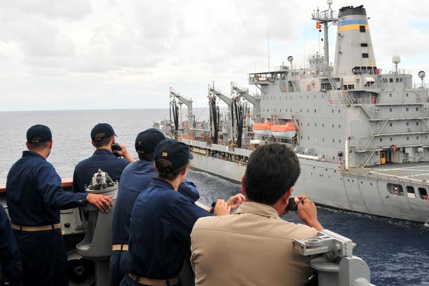 Capt. John M. Dorey, right, the commanding officer of the USS Anzio, and Lt. Cmdr. Elaine G. Luria, second from right, observe the ship's approach to the USNS Patuxent during an exercise Sept. 23, 2012, in the Straits of Florida. (U.S. Navy/Mass Communications Specialist 3rd Class Frank J. Pikul)