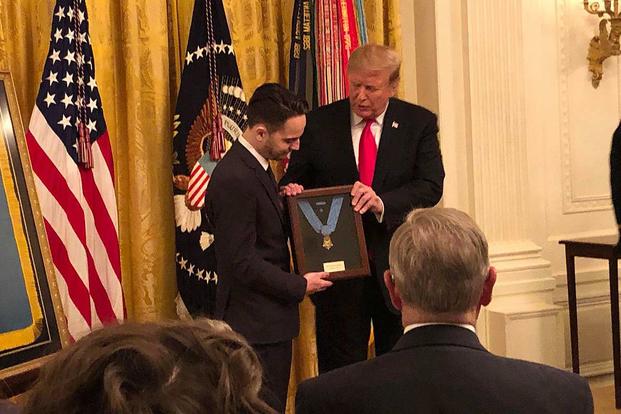 President Donald Trump presents the Medal of Honor on March 27, 2019, to Trevor Oliver, son of Army Staff Sgt. Travis Atkins, who died saving his fellow soldiers from a suicide bomber in Iraq. Army photo via Twitter