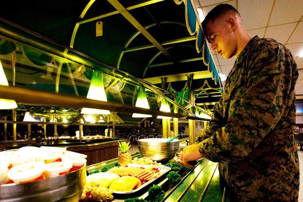 Lance Cpl. Alex Bosma, a helicopter mechanic with Marine Aviation Logistics Squadron 24 and native of Seattle, grabs a plate of fruit during breakfast (Cpl. James A. Sauter/U.S. Marine Corps photo)