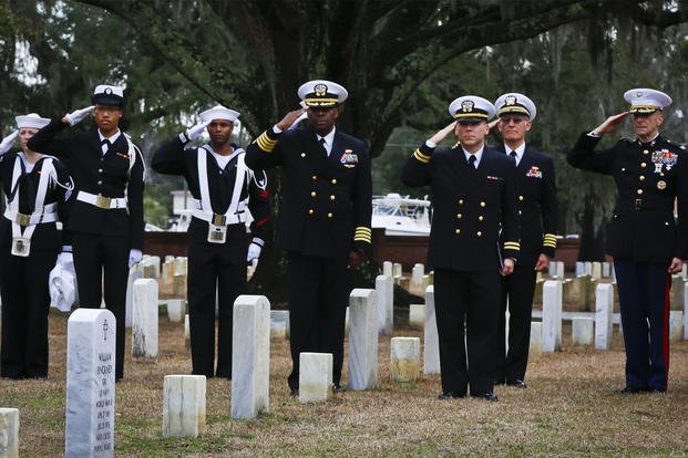 Marines and Sailors salute the headstone of Petty Officer 1st Class William Pinckney while Taps is played at the Beaufort National Cemetery, Feb. 10. (U.S. Navy/Lance Cpl. Christian Moreno)