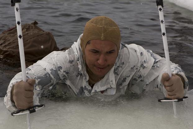 A U.S. Marine with Marine Rotational Force-Europe 19.2, Marine Forces Europe and Africa, uses ski poles to climb out of water during an ice-breaking drill in Setermoen, Norway, on May 4, 2019. The ice-breaking drills tested the Marines’ abilities to get out if they fall in freezing water, ultimately improving the Marine Corps’ cold-weather proficiencies. (U.S. Marine Corps photo by Sgt. Williams Quinteros)
