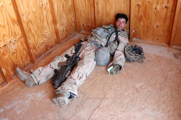 Pvt. Isaac Lemos of Alpha Company, 3rd Battalion, 15 Infantry Regiment, clutches a green casualty card while playing the role of a soldier killed in action during a May 8 urban battle at the National Training Center at Fort Irwin, California. Matthew Cox/Military.com