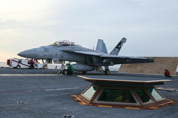 A sailor from the aircraft carrier Ford's air department loads an F/A-18F Super Hornet on to the electromagnetic aircraft launching system (EMALS). (Navy photo)