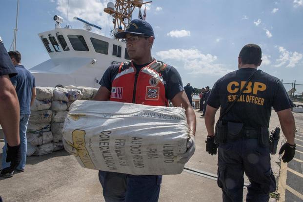 A crew member from Coast Guard Cutter Tarpon and his crew offload 1,735 kilograms of cocaine, Wednesday, May 3, 2017 at Coast Guard Sector St. Petersburg, Florida. (U.S. Coast Guard/Petty Officer 1st Class Michael De Nyse)