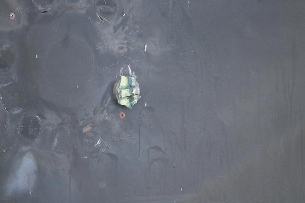 View shows remnants of a removed limpet mine’s placement, location, and damage sustained from a limpet mine attack, on the starboard side of motor vessel M/T Kokuka Courageous, while operating in the Gulf of Oman, June 13, 2019. (Photo: U.S. Navy)