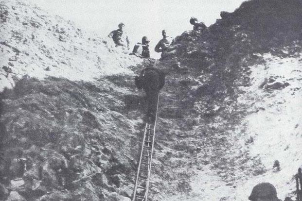 The sheer cliff walls the Rangers scaled, shown about two days after D-Day when it because a route for supplies. (Photo: U.S. Army)