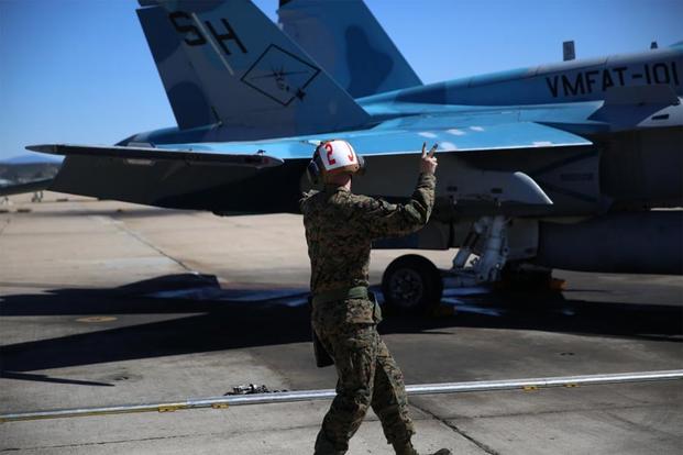 A Marine with Marine Fighter Attack Training Squadron (VMFAT) 101 perform routine maintenance on F/A-18 Hornets aboard Marine Corps Air Station Miramar, Calif., March 6., 2015. (U.S. Marine Corps/ Cpl. Michael Thorn)
