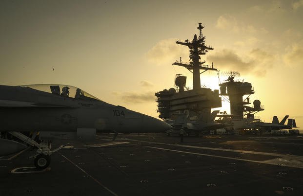 ARABIAN SEA (June 3, 2019) The sun sets behind the Nimitz-class aircraft carrier USS Abraham Lincoln (CVN 72). Abraham Lincoln Carrier Strike Group is deployed to the U.S. 5th Fleet area of operations in support of naval operations to ensure maritime stability and security in the Central Region, connecting the Mediterranean and the Pacific through the western Indian Ocean and three strategic choke points. (Jeff Sherman/Navy)