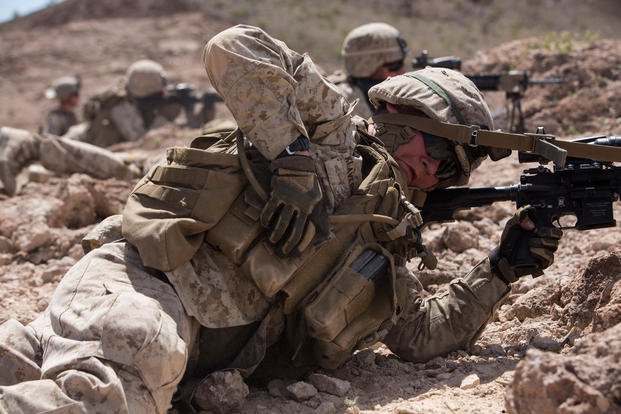 U.S. Marine Corps Pfc. Casey L. Klaverweiden, a rifleman with 3rd Platoon, Echo Company, 2nd Battalion, 6th Marine Regiment, 2nd Marine Division (2d MARDIV), reaches in his magazine pouch for ammunition during squad-level attack live fire training at Afghan Alley shooting range on U.S. Army Yuma Proving Grounds for Talon Exercise (TalonEx) 2-17, Yuma, A.Z., March 30, 2017. (U.S. Marine Corps photo/Tojyea G. Matally)