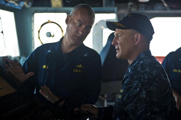 Rear Adm. Michael Gilday (right), then-commander of Carrier Strike Group 8, gets a tour of the guided-missile cruiser Hue City's bridge in 2013. Gilday is reportedly the nominee to become next chief of naval operations. (Matthew R. Cole/Navy)