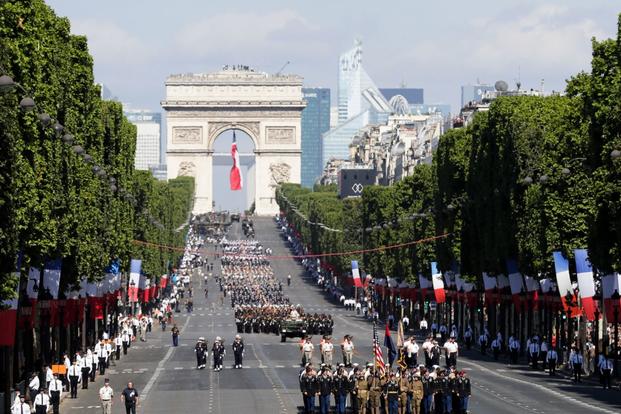 U.S troops march down the Champs Elysees avenue, with the Arc de Triomphe in background, during the Bastille Day parade in Paris on July 14, 2017.  (AP/Photo/Markus Schreiber)