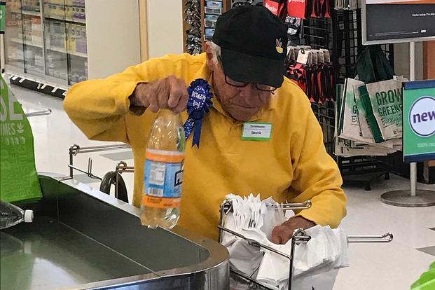 In this Aug. 20, 2019, photo, World War II veteran Bartolomeo "Benny" Ficeto, aka "Benny the Bagger," still works two shifts a week at his local Stop & Shop, where his co-workers marvel at his work ethic. Photo courtesy of Stop & Shop