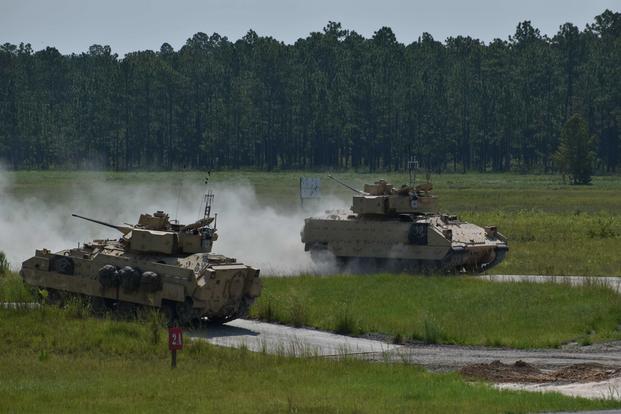 FILE -- A Bradley Fighting Vehicle passes another after completing a firing lane at Fort Stewart, Georgia.