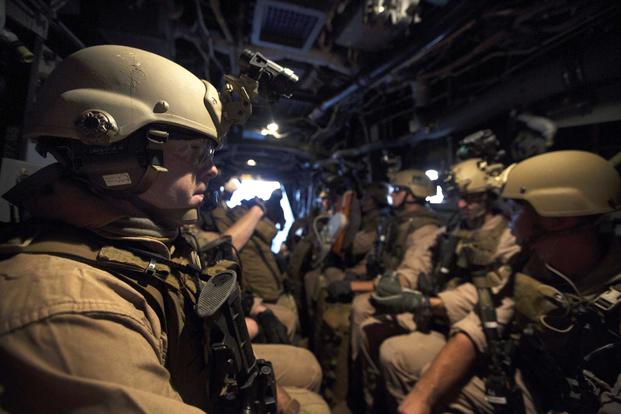 As seen through a night-vision device, Marines sit aboard an MV-22B Osprey before conducting a raid on a mock enemy compound during a composite training unit exercise at Camp Lejeune, N.C., on July 24, 2015. New technology may someday allow Marine infantrymen to see through the floor of an aircraft and track terrain features as they approach their attack objective. Marine Corps photo