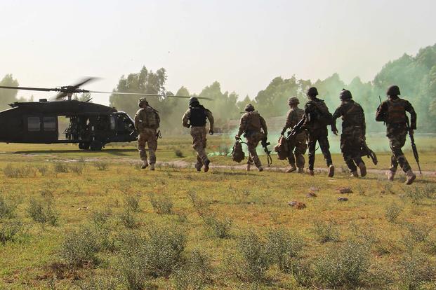 U.S. soldiers assigned to Train Advise Assist Command-East and Afghan National Army troops from 201st Corps exfil to a waiting UH-60 Black Hawk helicopter following a partnered force protection patrol in Laghman province on Sept. 23, 2015. (U.S. Army photo by Capt. Jarrod Morris)