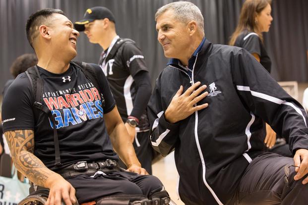 U.S. Army veteran Jhoonar Barrera converse with Chief executive officer Mike Linnington of Wounded Warrior Project after the wheelchair basketball competition for the 2017 Department of Defense Warrior Games at Chicago, Ill., June 29, 2017. (U.S. Army/Pfc. P.J. Siquig)
