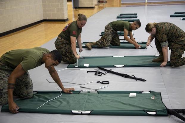 U.S. Marines prepare cots to house Marines and their families at Wallace Creek Fitness Center on Marine Corps Base Camp Lejeune, North Carolina, Sept. 4, 2019. Marines worked to ensure all equipment and personnel are prepared for Hurricane Dorian. (U.S. Marine Corps/Cpl. Alexia Lythos)
