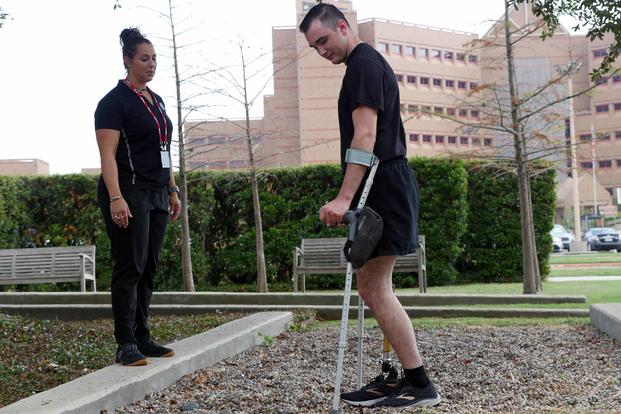 Candace Pellock, a physical therapy assistant, guides Spc. Ezra Maes at the Center for the Intrepid, Brooke Army Medical Center’s cutting-edge rehabilitation center at Joint Base San Antonio-Fort Sam Houston, Texas, on Oct. 2, 2019. (U.S. Army photo by Corey Toye)