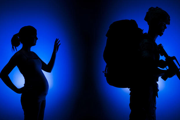A woman and man pose in a deployment illustration. (U.S. Marine Corps/ Photo by Sgt. Mark Fayloga)