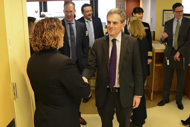 Dr. Steven Lieberman, acting principal deputy under secretary for health for the Veterans Health Administration, greets a staff member of Captain James A. Lovell Federal Health Care Center during a tour of the facility, on March 7, 2019. (U.S. Navy photo by Mass Communication Specialist 2nd Class Weston A. Mohr)
