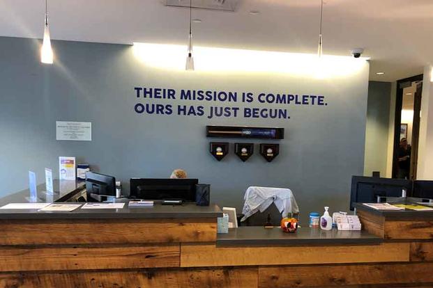 The front desk at Home Base in Charlestown, Mass., was designed by veterans and meant to evoke the legendary warship USS Constitution, moored just yards away.  (Hope Hodge Seck/Military.com)