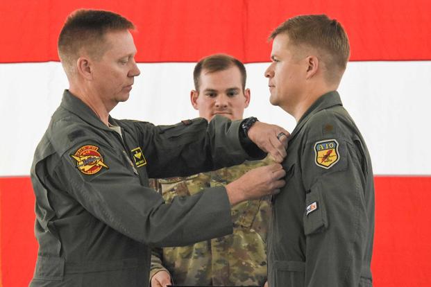 Col. Mike Schultz, commander of the 442d Fighter Wing, pins the Distinguished Flying Cross on Maj. John Tice, a flight commander with the 303d Fighter Squadron, during a ceremony at Whiteman Air Force Base, Mo., Nov. 2, 2019. (U.S. Air Force/Airman 1st Class Alex Chase)