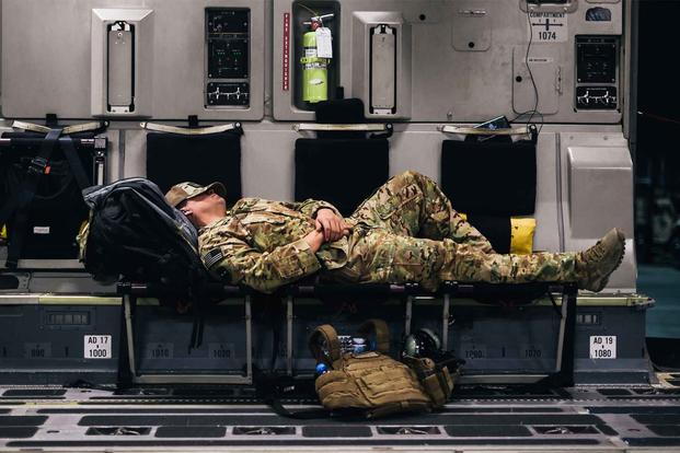 A U.S. Air Force Airman sleeps inside a C-17 Globemaster III during a flight over an undisclosed location in support of Operation Freedom Sentinel, Jan. 22, 2018. (U.S. Air Force illustration)