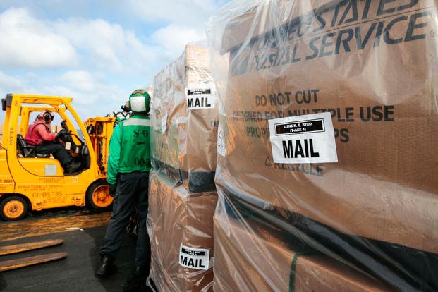 Sailors transport mail on USS Abraham Lincoln
