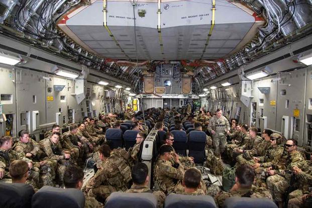 Paratroopers from the 82nd Airborne board a C-17 at Camp Taji, Iraq.