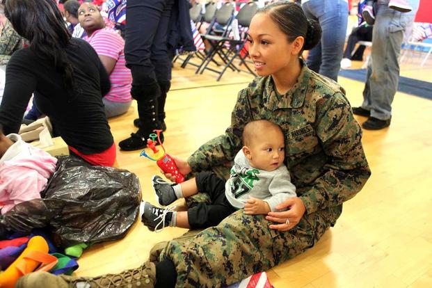 A Marine with Marine Aircraft Group 31 holds her son.