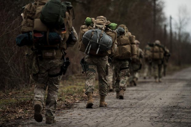U.S. Airmen assigned to the 435th Security Forces Squadron carry their supplies to a rally point