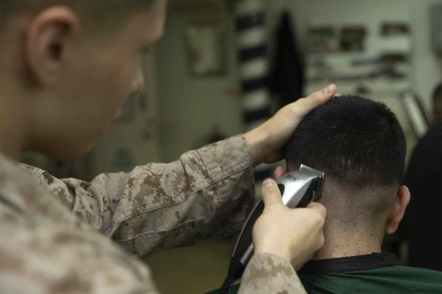 A Marine gets his hair cut in the barber shop aboard the USS Kearsarge, Jan. 21, 2019. 