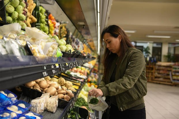 An airman bags onions at the commissary.