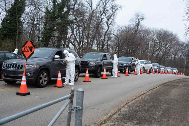 Drivers line up at the entrance of a coronavirus test center.