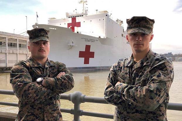 Sgt. Austin Loppe, left, and Lance Cpl. Colton Flach in front of the USNS Comfort. Marine Corps photo