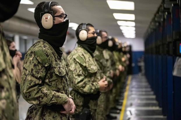 Recruits stand by for instruction in USS Wisconsin Live Fire Marksmanship Trainer at Recruit Training Command, April 27, 2020.
