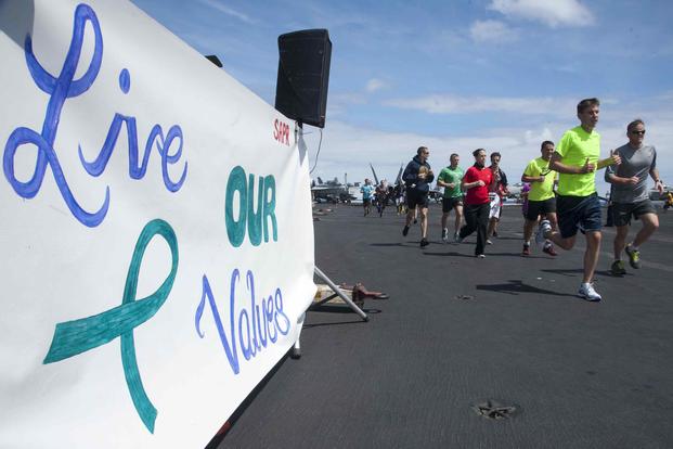 Sailors and Marines participate in a 5k run in support of Sexual Assault Awareness Month on the aircraft carrier USS Harry S. Truman.