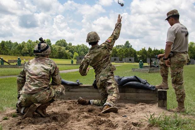 Cadet Samuel Gordon throws a dummy grenade towards the target during the hand grenade qualification course at Fort Knox.